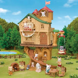 Sylvanian Families Lakeside Lodge connected with a taller tree house, long slide and swing, surrounded by miniature animal figures.