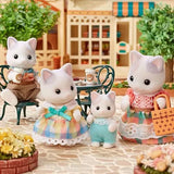 Latte Cat figures shown beside a small table with cups and flowers