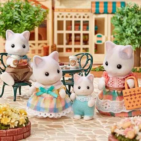 Latte Cat figures shown beside a small table with cups and flowers