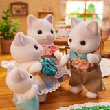 Four white cat figures shown in a room scene with a blue knitted accessory