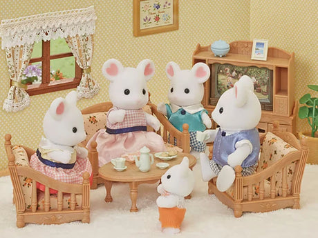 Four Marshmallow Mouse figures shown in a living room scene with sofas, table and cabinet