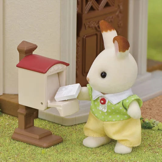 Sylvanian rabbit figure shown beside a white mailbox with paper visible