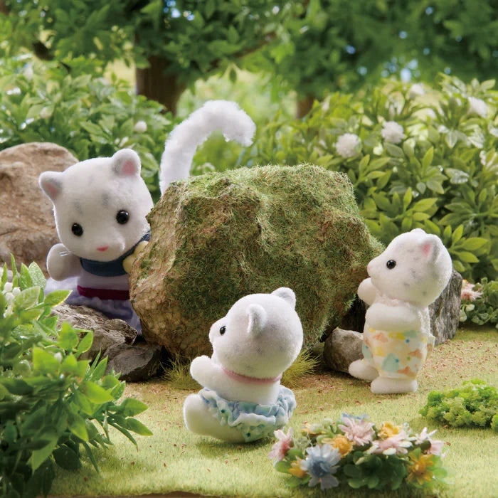 Snow Leopard figures shown in a garden scene with flowers and greenery
