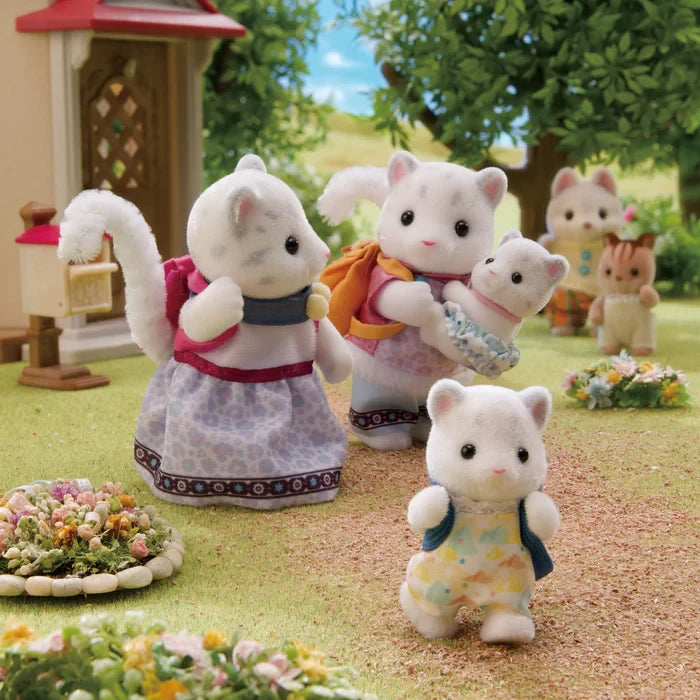 Snow Leopard Family figures shown in a village scene with other Sylvanian figures visible
