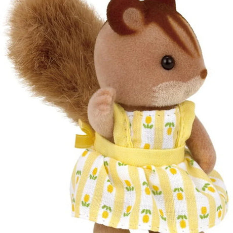 Squirrel figure in a yellow dress shown from the side close up
