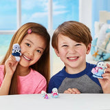 Smiling girl and boy holding Sylvanian Families Seal Family parent figures, with the two miniature baby seals displayed on the table between them.