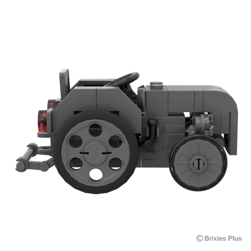 Massey Ferguson TEA 20 Mini BRIXIES model in full side profile facing right with the steering wheel, grey body and rear hitch visible