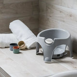 Thermobaby Aquafun Grey Bath Ring beside bath towels and stacking cups