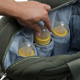 Open Thermobaby Pluméa Cactus Green changing bag showing three bottles in interior pockets