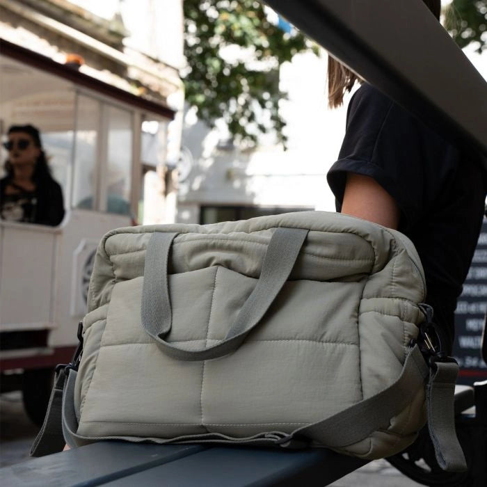 Thermobaby Pluméa Cactus Green changing bag being carried by the top handles