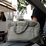 Thermobaby Pluméa Cactus Green changing bag being carried by the top handles