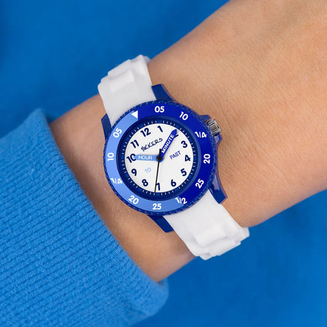 Tikkers White Silicone Time Teacher Watch worn on the wrist with white silicone strap, blue case and time teacher dial