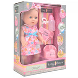 Tiny Tears Classic Crying & Wetting with Hair shown in the retail box with long blonde hair, floral dress, bottle, dummy, pull up underwear and potty visible