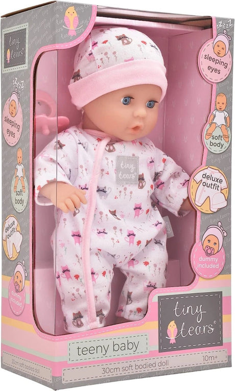 Tiny Tears Teeny Baby packaging shown from a front and side angle with the doll, pink dummy and sleeping eyes, soft body, deluxe outfit and dummy feature graphics visible