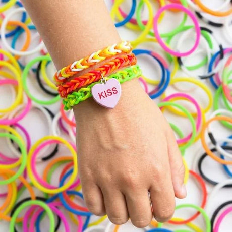 TOPModel loom band bracelets on a wrist over loose colourful bands