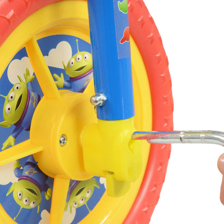 Close up of the yellow pedal area and wheel with Toy Story alien graphics