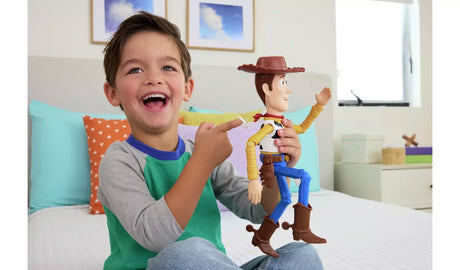 Child holding the Toy Story 5 Running Woody figure and pointing to the pull string ring