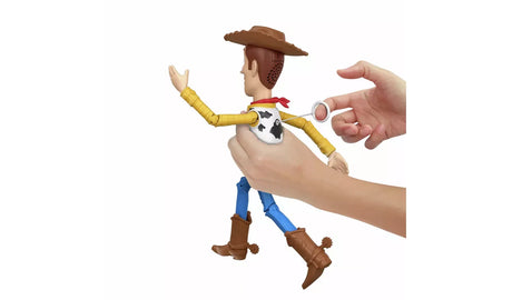 Hands holding the Toy Story 5 Running Woody figure and pulling the string on his back
