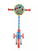 Front-facing view of the Toy Story Deluxe Tri Scooter showing Toy Story character handlebar disc, red grips, blue alien-printed stem and three red and yellow wheels