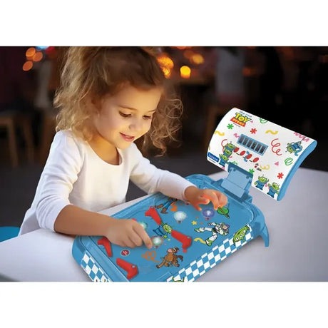 Child playing the Lexibook Toy Story electronic table pinball at a table