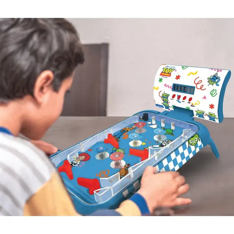 Child using the red side flipper controls on the Toy Story electronic table pinball