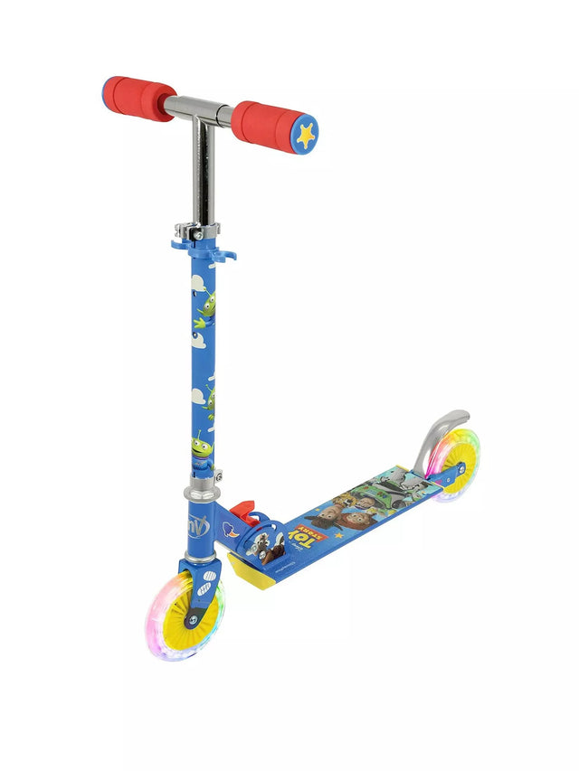 Front side view of the Toy Story inline scooter showing blue alien-printed stem, red foam grips with sheriff star end caps, Toy Story character deck graphic and two light-up yellow inline wheels