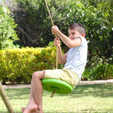 Child using the lime TP Button Swing Seat outdoors