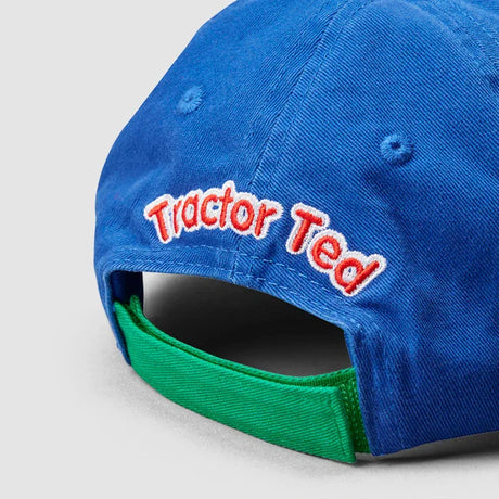 Close up of embroidered Tractor Ted logo text on back of blue cap with green strap
