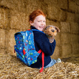 Tractor Ted character Midge in a farmyard setting with a yellow background.