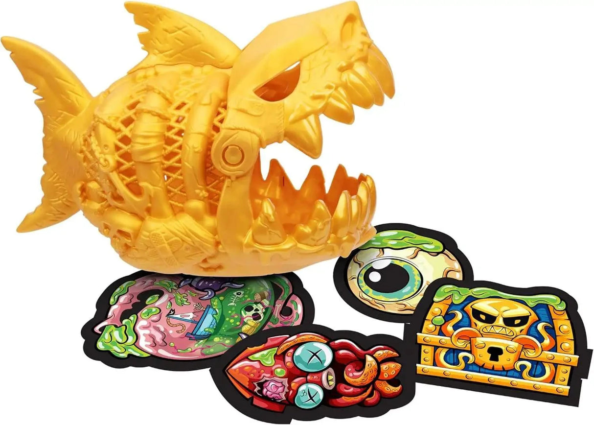 Treasure X Shark Dissection gold moulded shark figure shown open with four illustrated collectible sticker cards laid out in front