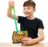 Child pulling green slime and worm-shaped surprises from an opened Treasure X Shark Dissection treasure chest, showing the dissection play experience