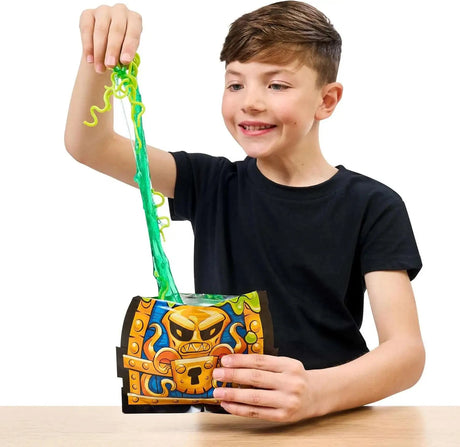 Child pulling green slime and worm-shaped surprises from an opened Treasure X Shark Dissection treasure chest, showing the dissection play experience