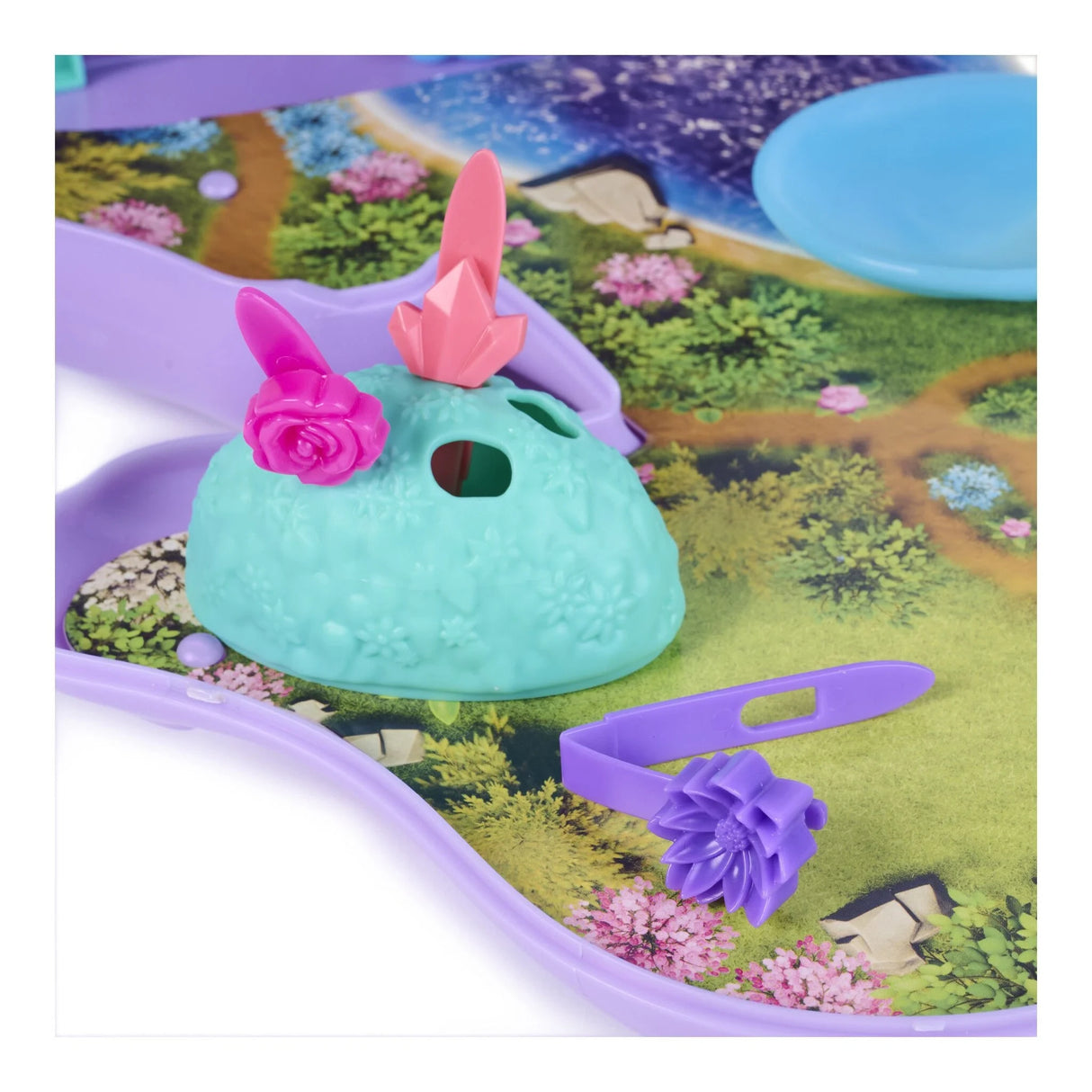 Turquoise textured accessory with pink decorations beside a purple brush inside the Wildstar playset