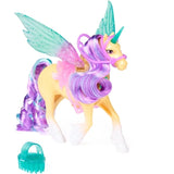 Unicorn Academy Leaf unicorn standing with raised turquoise and pink translucent wings, curled purple and turquoise mane and tail, pink bridle and white hooves, with a turquoise grooming brush beside her.