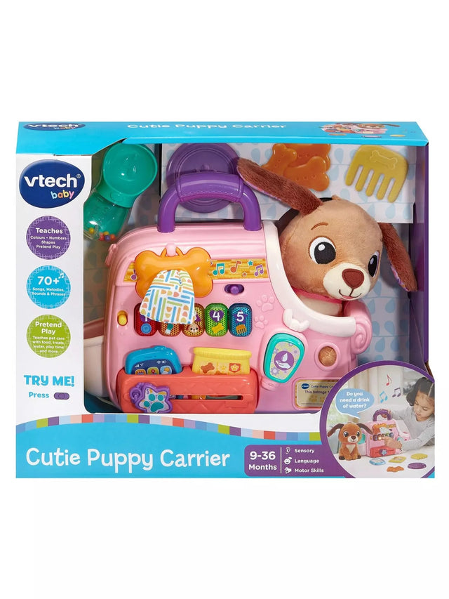 VTech Baby Cutie Puppy Carrier in retail box showing pink carrier with plush puppy, numbered keys, and role-play accessories for ages 9 to 36 months