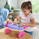 Child playing the VTech Bluey Sing-Along Keyboard on a table with the yellow microphone attached
