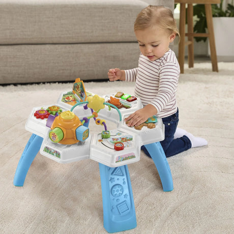Child playing with VTech Busy Bee Activity Table featuring lights, gears and interactive zones – Ireland