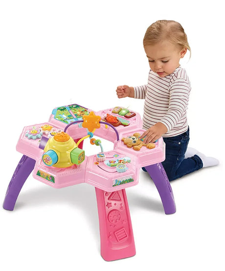 Child playing with VTech Busy Bee Activity Table Pink featuring interactive learning zones – Ireland