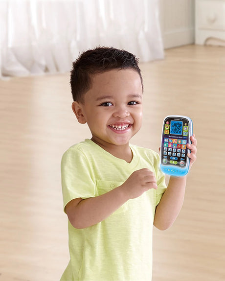Child holding VTech Chat & Discover Phone with animal icons and number buttons visible