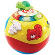 Close up angled view of VTech Crawl and Learn Bright Lights Ball pink version showing green turtle on spinning disc, illuminated number buttons 1 to 5 and raised rabbit and red cat characters