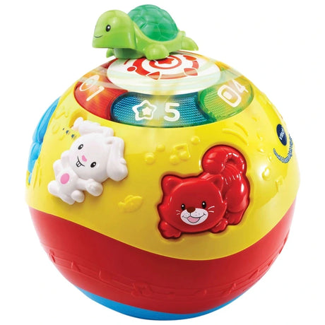 Close up angled view of VTech Crawl and Learn Bright Lights Ball pink version showing green turtle on spinning disc, illuminated number buttons 1 to 5 and raised rabbit and red cat characters