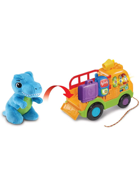 Blue plush T-Rex dinosaur shown beside the VTech Dino Rescue Truck with tailgate open – Ireland.
