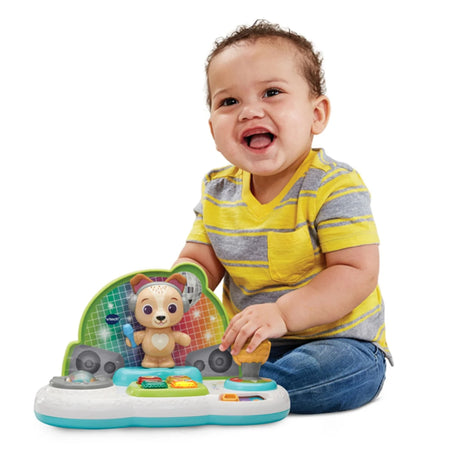 Baby playing with VTech DJ Jams Puppy music toy and microphone – Ireland.