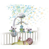 VTech Lullaby Lambs Mobile attached to cot above baby with star projection on the wall