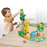 Child at table with VTech Marble Rush Junior Safari Slides track layout and animal marbles