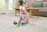 Child sitting on a rug with the VTech My Everyday Gadgets phone and toy keys in front of them 