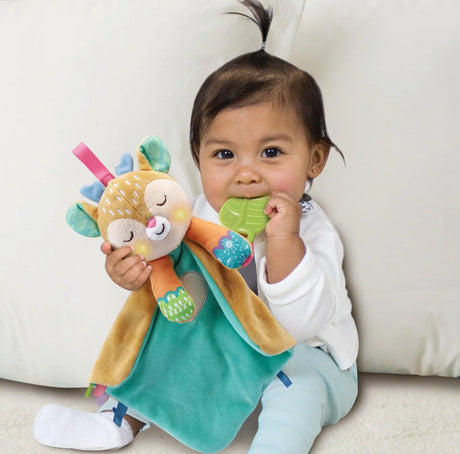 Baby holding VTech My Friend Fawn soft toy with teether accessory – Ireland