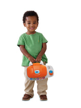 Child holding the closed VTech My Laptop by its handle
