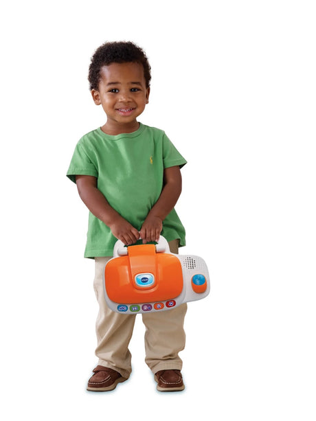Child holding the closed VTech My Laptop by its handle