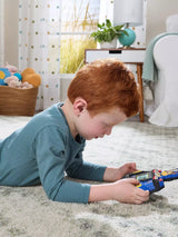 Child lying on a rug using the VTech PAW Patrol Chase Game & Go